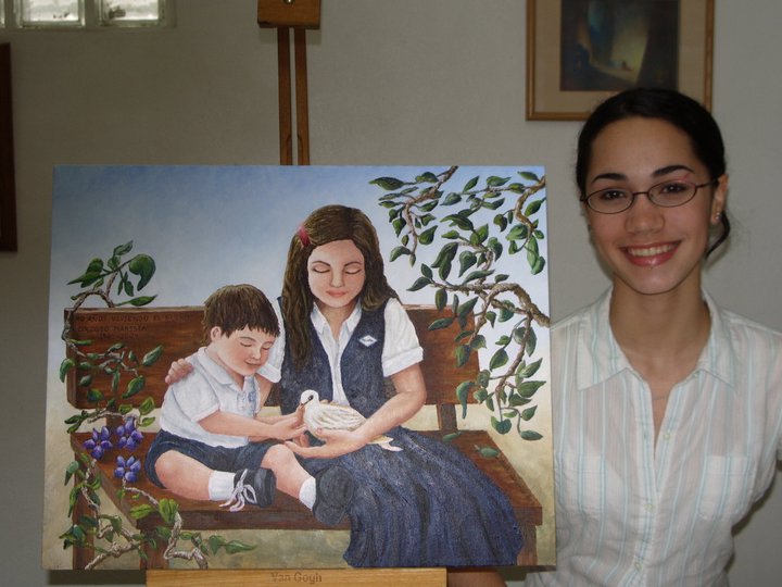 Student Laura shows painting of school children