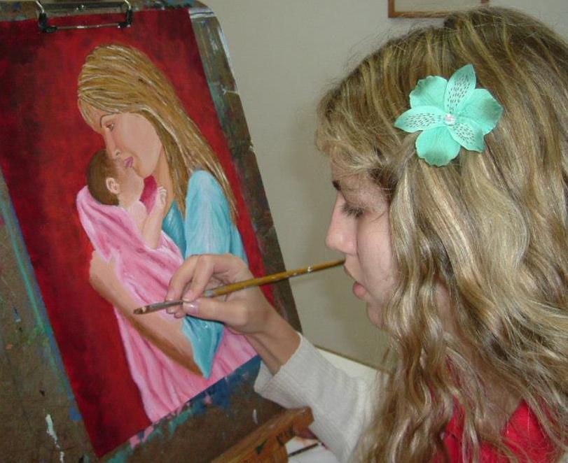 Student Michelle painting with acrylics